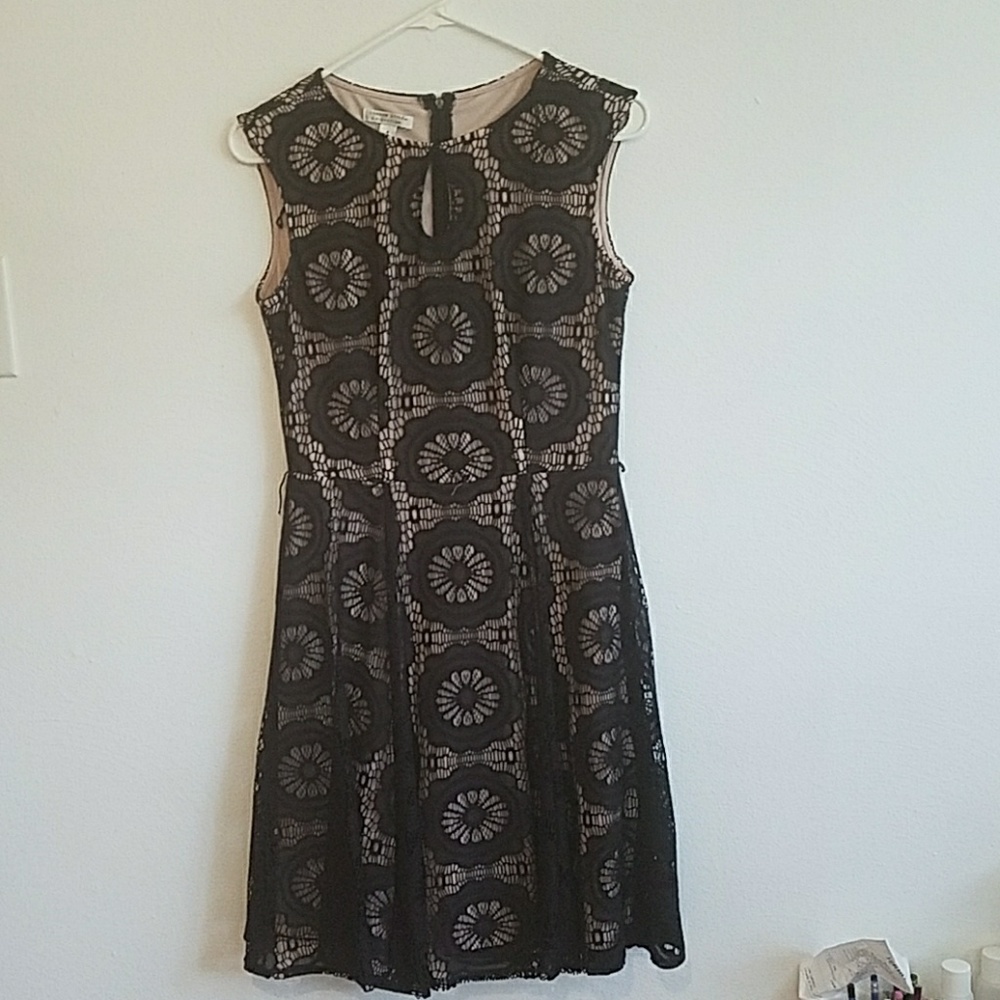Fit and flare dress with black lace over nude.